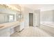 Main bathroom with double vanity, soaking tub, and shower at 1719 Bayhill Dr, Oldsmar, FL 34677