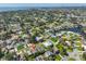 An aerial view shows the property among a neighborhood with mature trees and waterways leading to the bay and ocean at 1727 New Hampshire Ne Ave, St Petersburg, FL 33703