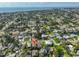 An aerial view shows the property among a neighborhood with mature trees and waterways leading to the bay and ocean at 1727 New Hampshire Ne Ave, St Petersburg, FL 33703