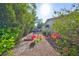 Backyard area with a planting beds and lush tropical landscaping at 1727 New Hampshire Ne Ave, St Petersburg, FL 33703