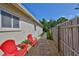 Backyard patio with stone pavers, string lights, privacy fence and tropical landscaping at 1727 New Hampshire Ne Ave, St Petersburg, FL 33703