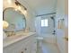 Modern bathroom featuring marble tile, updated lighting, a white vanity and tub at 1727 New Hampshire Ne Ave, St Petersburg, FL 33703