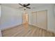 Bright bedroom with light wood floors, ceiling fan and a closet at 1727 New Hampshire Ne Ave, St Petersburg, FL 33703