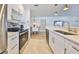 Well-lit kitchen featuring white cabinetry, modern appliances, and a view into the dining area at 1727 New Hampshire Ne Ave, St Petersburg, FL 33703