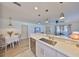 Well-lit kitchen area featuring stainless steel appliances, a breakfast bar, and an open layout to dining and living spaces at 1727 New Hampshire Ne Ave, St Petersburg, FL 33703
