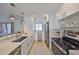 Bright kitchen featuring white cabinets, stainless steel appliances, and an open layout for easy entertaining at 1727 New Hampshire Ne Ave, St Petersburg, FL 33703