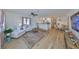 Open-concept living space with stylish furnishings, modern lighting, and seamless flow to the kitchen and dining area at 1727 New Hampshire Ne Ave, St Petersburg, FL 33703