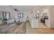 Open-concept living area with modern kitchen, natural light, and hard wood floors at 1727 New Hampshire Ne Ave, St Petersburg, FL 33703