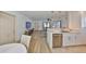 Bright, open-concept living area showcasing modern kitchen, natural light, and wood-look floors at 1727 New Hampshire Ne Ave, St Petersburg, FL 33703