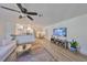 Bright living room featuring hardwood floors, a ceiling fan, and an open layout to the kitchen and dining area at 1727 New Hampshire Ne Ave, St Petersburg, FL 33703