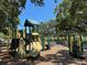 A colorful playground with slides, climbing structures, and a soft landing surface for recreation at 1727 New Hampshire Ne Ave, St Petersburg, FL 33703