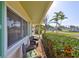 Cozy porch with comfortable seating, vibrant flowers, and a view of the lush greenery and street beyond at 1727 New Hampshire Ne Ave, St Petersburg, FL 33703