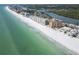 Stunning aerial view of condos bordering a white sandy beach and beautiful aqua-blue ocean at 18650 Gulf Blvd # 313, Indian Shores, FL 33785