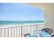 Relaxing balcony view overlooking the beach with turquoise water, complete with cozy seating for enjoying ocean breezes at 18650 Gulf Blvd # 313, Indian Shores, FL 33785