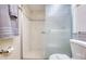 Bathroom featuring walk-in shower with glass door and neutral tile at 18650 Gulf Blvd # 313, Indian Shores, FL 33785