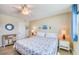 Cozy bedroom featuring ample natural light, a ceiling fan, neutral tones, and coastal decor for a relaxed atmosphere at 18650 Gulf Blvd # 313, Indian Shores, FL 33785