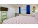 Charming bedroom with playful flamingo bedding, ample storage, a mermaid decoration and a sunny window at 18650 Gulf Blvd # 313, Indian Shores, FL 33785