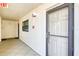 Hallway leading to unit with door featuring storm door at 18650 Gulf Blvd # 313, Indian Shores, FL 33785