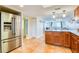 Bright kitchen with stainless steel refrigerator, granite counters, and tile floor, adjacent to the living area at 18650 Gulf Blvd # 313, Indian Shores, FL 33785