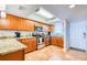 Functional kitchen featuring stainless steel appliances, granite countertops, and wood cabinets at 18650 Gulf Blvd # 313, Indian Shores, FL 33785