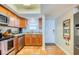 Fully equipped kitchen includes stainless steel appliances, wood cabinets, and tile flooring at 18650 Gulf Blvd # 313, Indian Shores, FL 33785