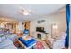 Charming living room with cozy seating, a TV, decorative rug, and access to kitchen at 18650 Gulf Blvd # 313, Indian Shores, FL 33785