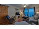 Relaxing living room with a balcony overlooking the ocean, comfortable seating, and beach decor at 18650 Gulf Blvd # 313, Indian Shores, FL 33785