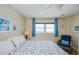 Bright and airy main bedroom boasts ocean views, light walls, a ceiling fan and nautical decor for a tranquil space at 18650 Gulf Blvd # 313, Indian Shores, FL 33785