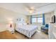 A calming main bedroom with ocean view, featuring coastal decor, a ceiling fan, and comfortable furnishings at 18650 Gulf Blvd # 313, Indian Shores, FL 33785