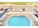 Community pool with lounge chairs and tables overlooking waterway at 18650 Gulf Blvd # 313, Indian Shores, FL 33785