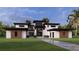 Stunning modern home with a meticulously manicured lawn and a striking architectural design at 19207 Gunn Hwy, Odessa, FL 33556