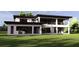 Rear view of modern home showcasing large windows and an open patio area, perfect for gatherings at 19207 Gunn Hwy, Odessa, FL 33556