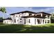 The back of the house is adorned with big glass windows and a balcony for an awesome view at 19207 Gunn Hwy, Odessa, FL 33556