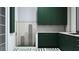 Stylish bathroom with green cabinets, custom shower and unique tile flooring at 19211 Gunn Hwy, Odessa, FL 33556