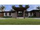 Modern home with grand entryway, mature landscaping, and covered entry for a welcoming first impression at 19211 Gunn Hwy, Odessa, FL 33556