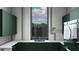 Chic laundry room with green cabinets, modern appliances, and stylish tiled walls and countertop at 19211 Gunn Hwy, Odessa, FL 33556