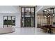 Bright, open-concept living room featuring a modern chandelier, marble floors, and a dining area with a wine cellar at 19211 Gunn Hwy, Odessa, FL 33556