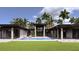 Luxurious backyard pool with integrated spa, covered patio, and lush lawn, ideal for relaxation and recreation at 19211 Gunn Hwy, Odessa, FL 33556