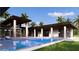 Backyard pool with integrated spa and modern covered patio, ideal for outdoor relaxation and entertaining at 19211 Gunn Hwy, Odessa, FL 33556