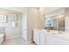 Bathroom showcasing double sinks, white cabinets, a soaking tub, and a separate glass shower at 19720 Gladeview Way, Land O Lakes, FL 34638