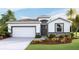 Charming one-story home featuring a two-car garage, neutral paint and beautifully landscaped front yard at 19720 Gladeview Way, Land O Lakes, FL 34638