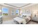 Serene main bedroom featuring neutral tones, tray ceiling, lots of natural light, and stylish decor at 19720 Gladeview Way, Land O Lakes, FL 34638