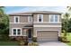 Two-story home with stone accents, neutral paint and a two car garage at 19752 Gladeview Way, Land O Lakes, FL 34638