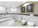 Clean, bright bathroom with a jacuzzi tub, toilet, and unique tile work for a spa-like experience at 19910 Gulf Boulevard # 102, Indian Shores, FL 33785