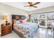 Bright bedroom with balcony access, ceiling fan, and elegant decor, perfect for relaxing and enjoying the view at 19910 Gulf Boulevard # 102, Indian Shores, FL 33785