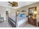 Cozy bedroom featuring a four-poster bed, ceiling fan, and decorative touches for a serene atmosphere at 19910 Gulf Boulevard # 102, Indian Shores, FL 33785