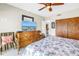 Comfortable bedroom with ceiling fan, TV, and wooden furniture for a relaxing and functional space at 19910 Gulf Boulevard # 102, Indian Shores, FL 33785