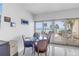 Cozy dining area with ocean view, seating for four, and access to outdoor seating at 19910 Gulf Boulevard # 102, Indian Shores, FL 33785