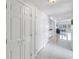Bright hallway showcasing white tile flooring and access to an ocean view at 19910 Gulf Boulevard # 102, Indian Shores, FL 33785