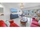 Comfortable living room with large TV, ocean view, and access to the balcony at 19910 Gulf Boulevard # 102, Indian Shores, FL 33785